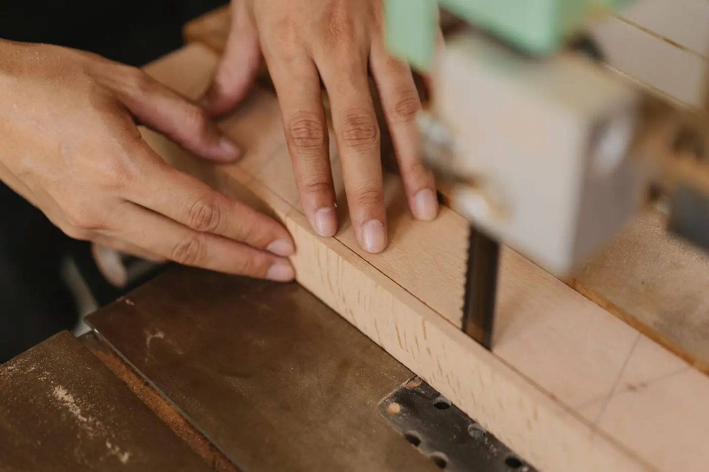 Seen from above, a woodworker sawing lumber on a band saw