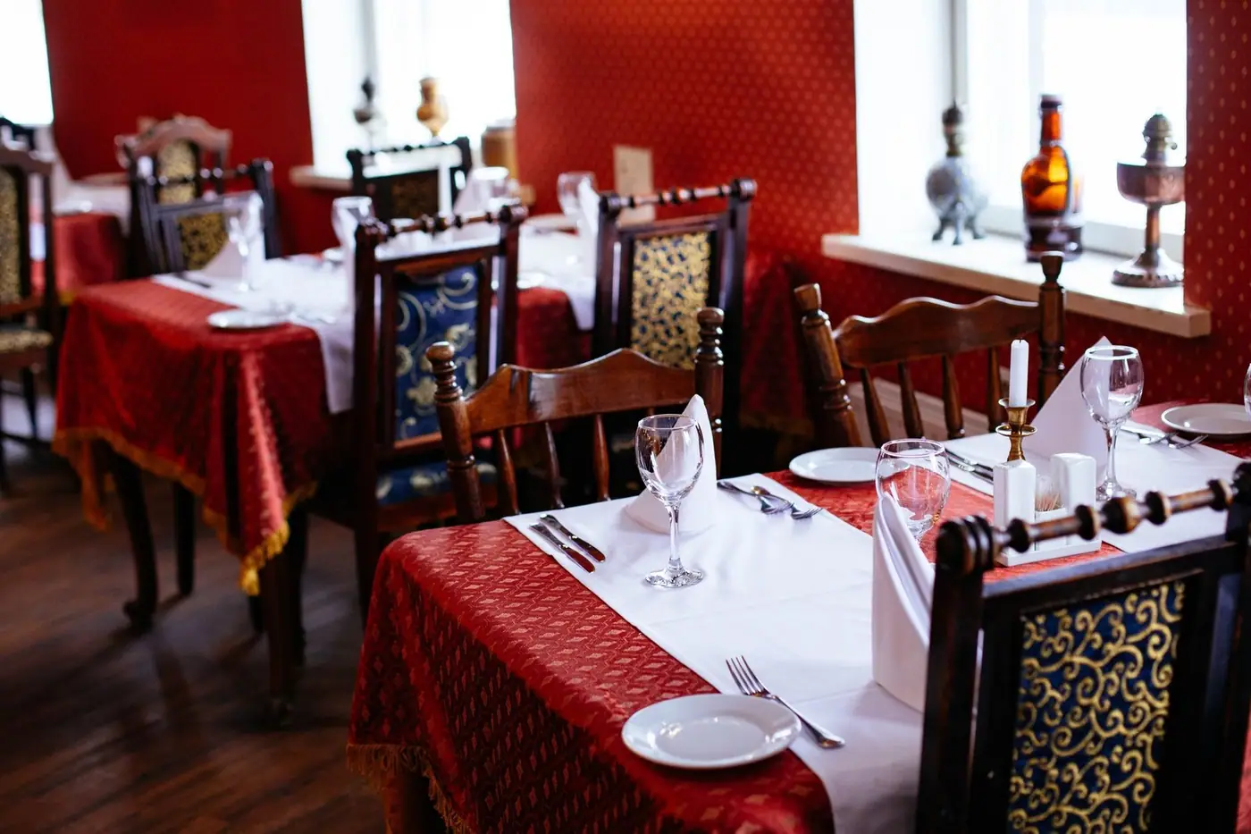 Lavishly set dining tables with elegant cutlery and rich decor