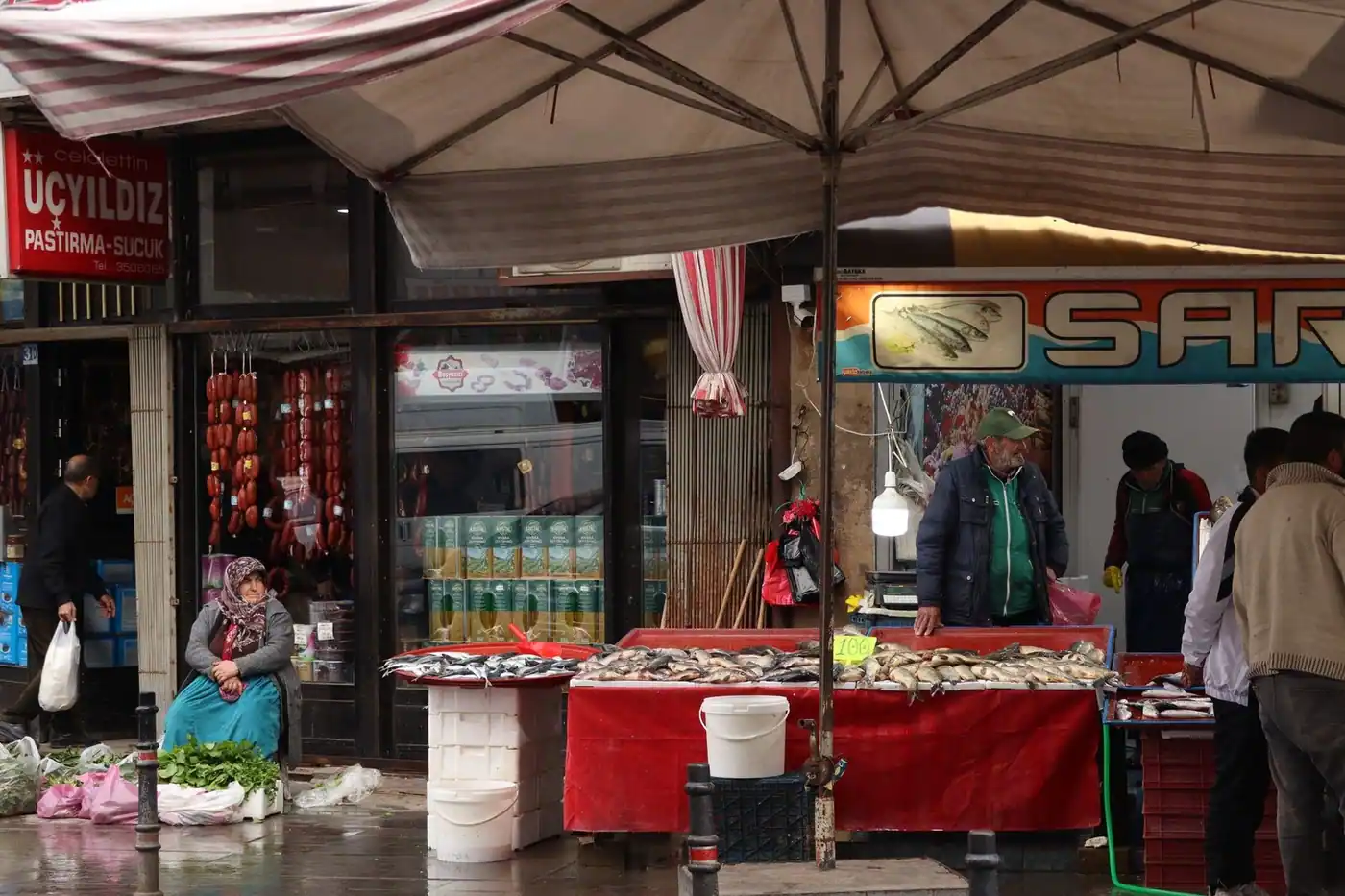 A bustling street market with a stall of fresh fish