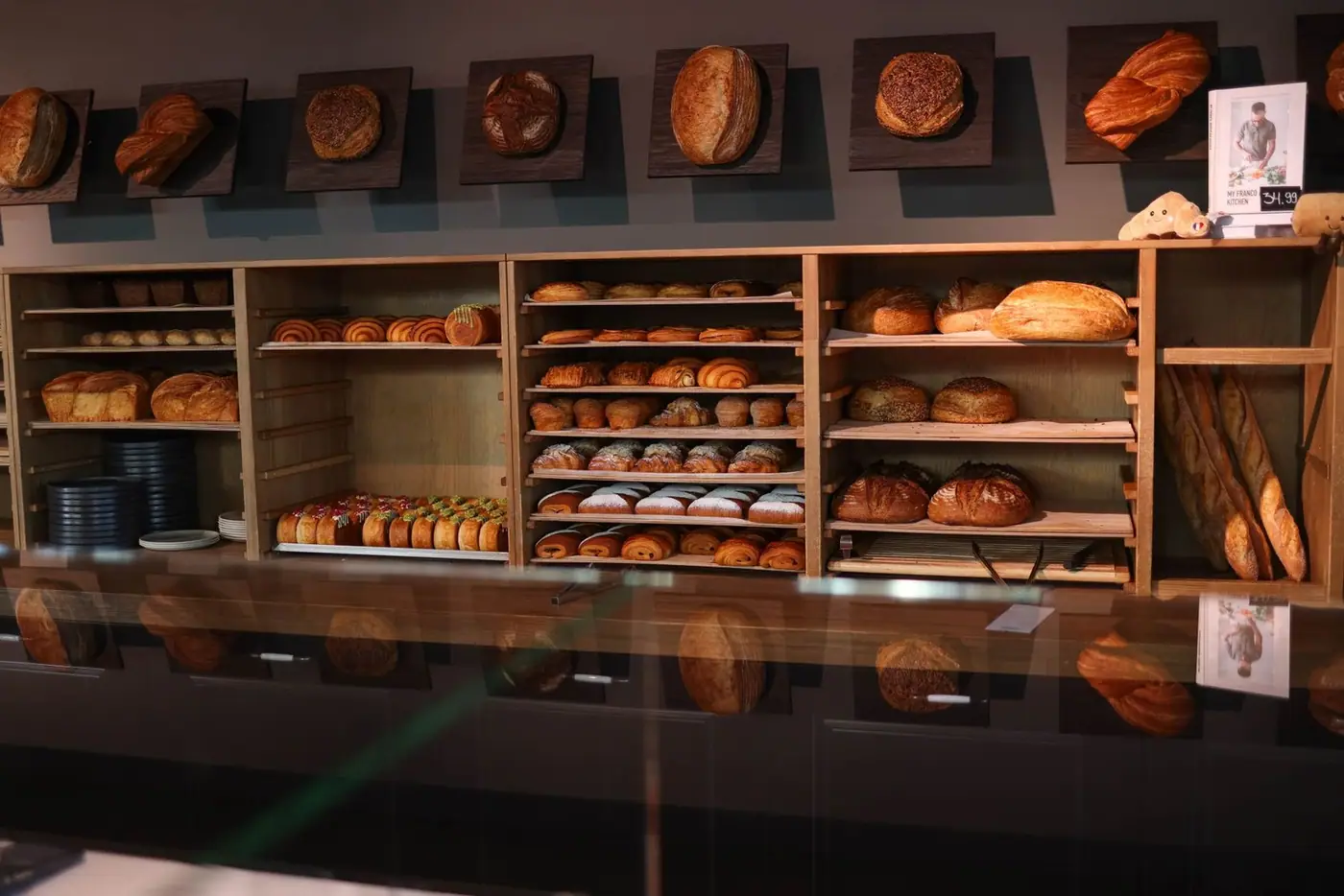 Freshly baked bread and pastries on wooden shelves