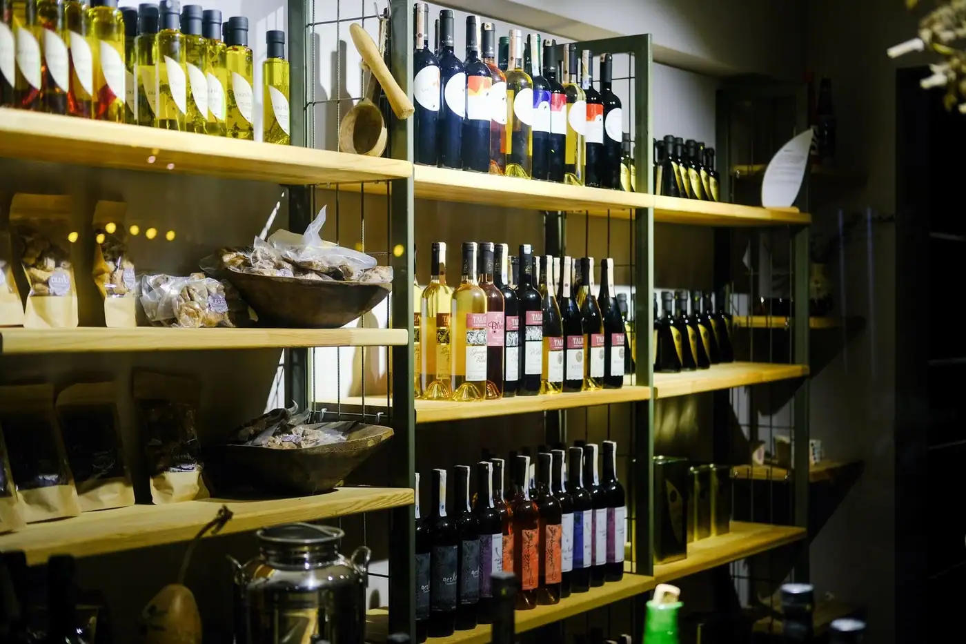 A variety of bottles displayed on wooden shelves in a retail store