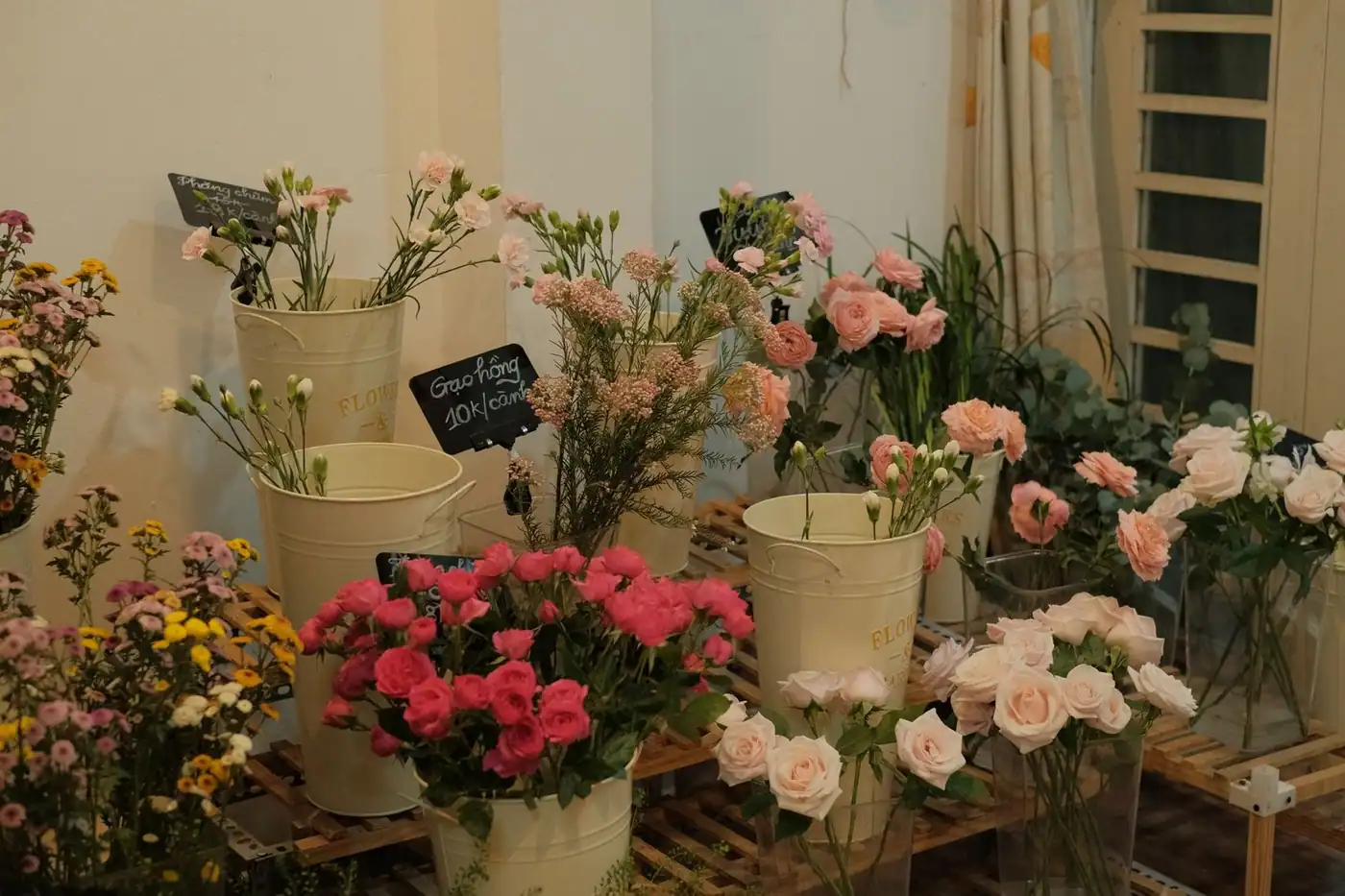 An indoor display of various flowers in an elegant setting