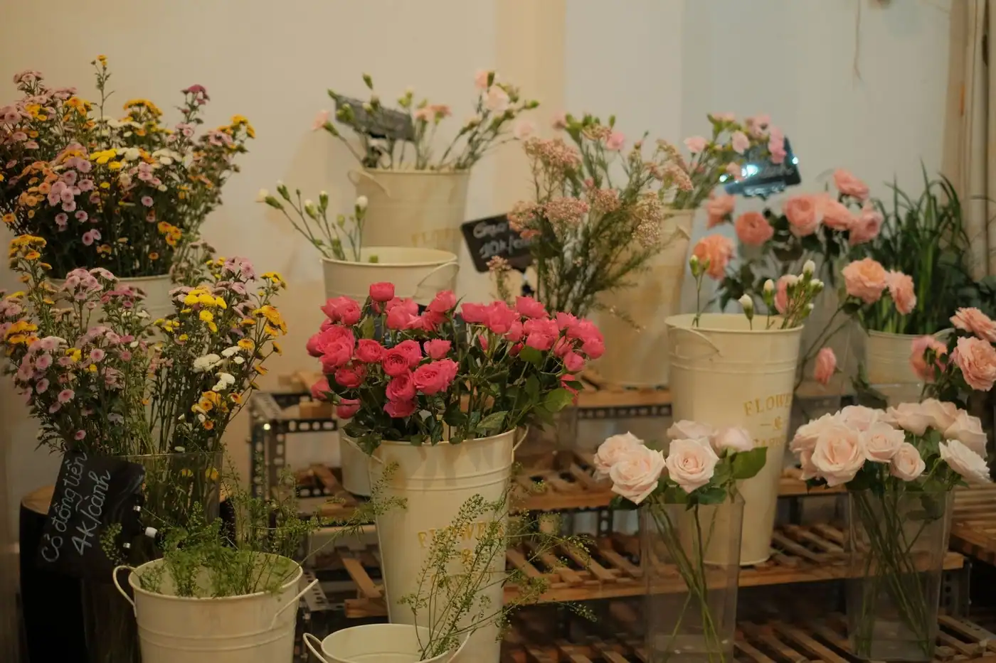 Vibrant flowers in rustic buckets inside a cosy flower shop