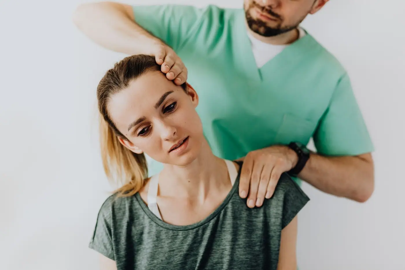 Massage therapist gently massaging a client's neck and shoulders