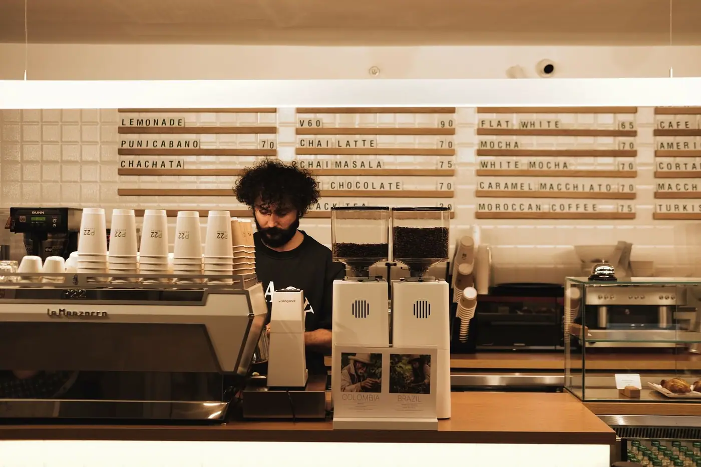 A barista making coffee on a professional espresso machine