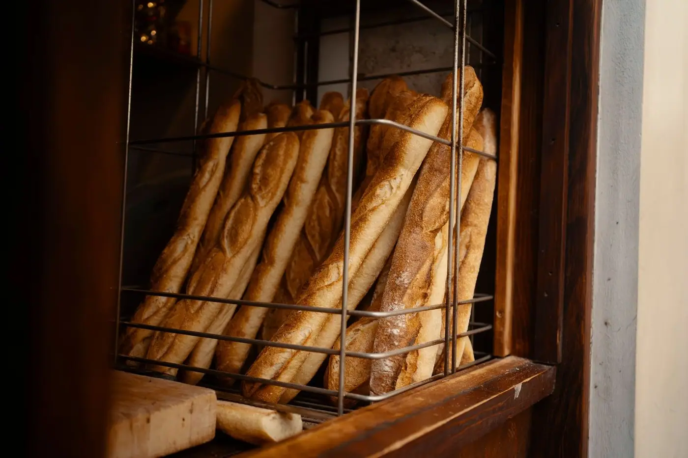 Fresh baguettes stacked in a bakery display