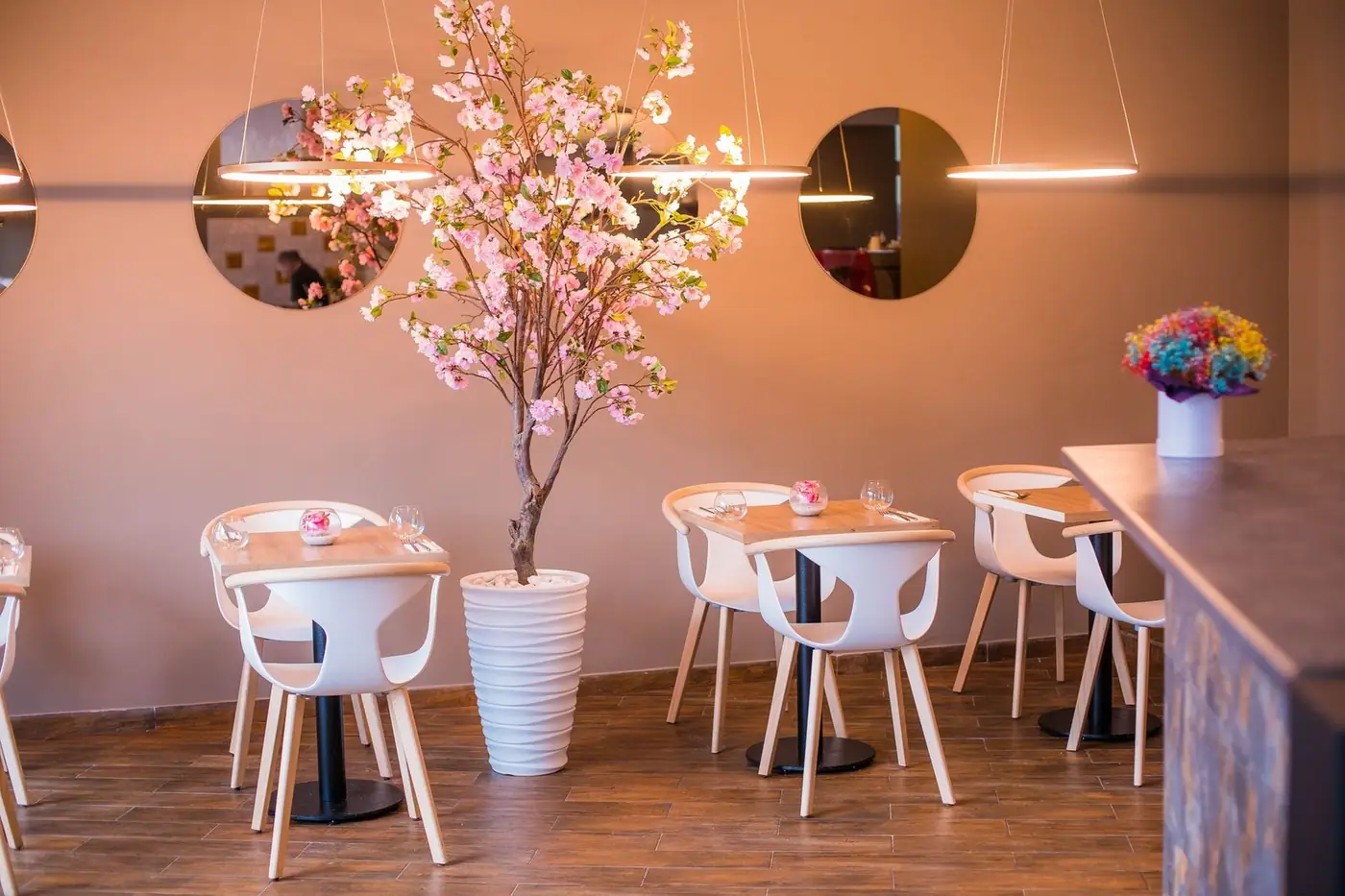 Stylish restaurant interior with cherry blossom decor and modern furniture