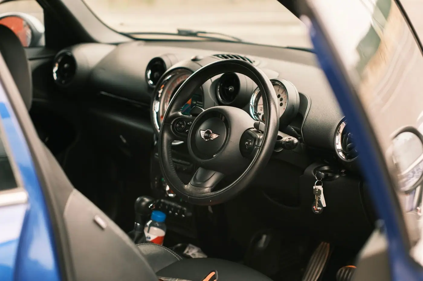 Close-up of a car interior with steering wheel and dashboard.