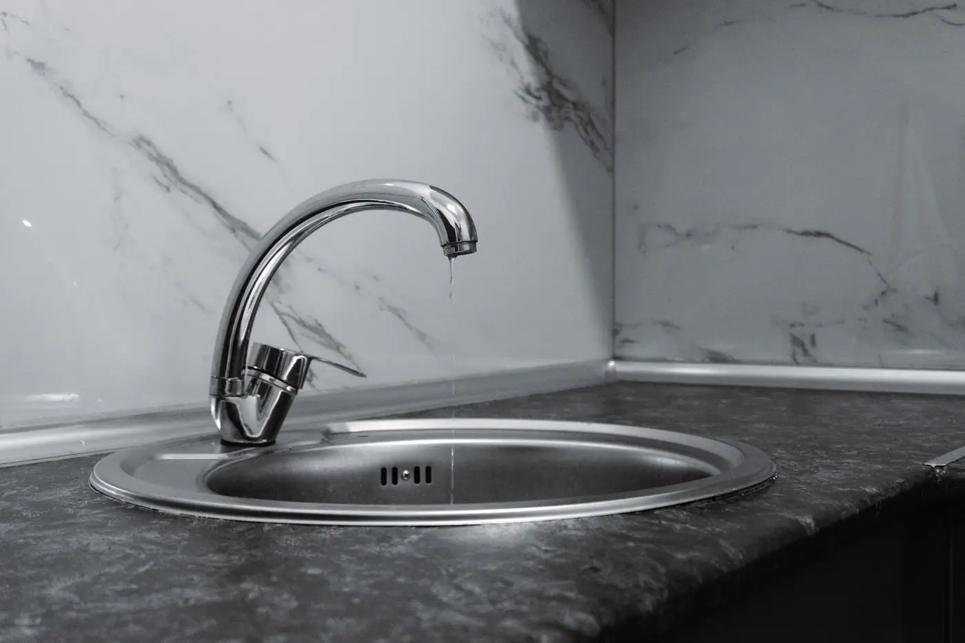 A clean, modern kitchen sink with a chrome tap