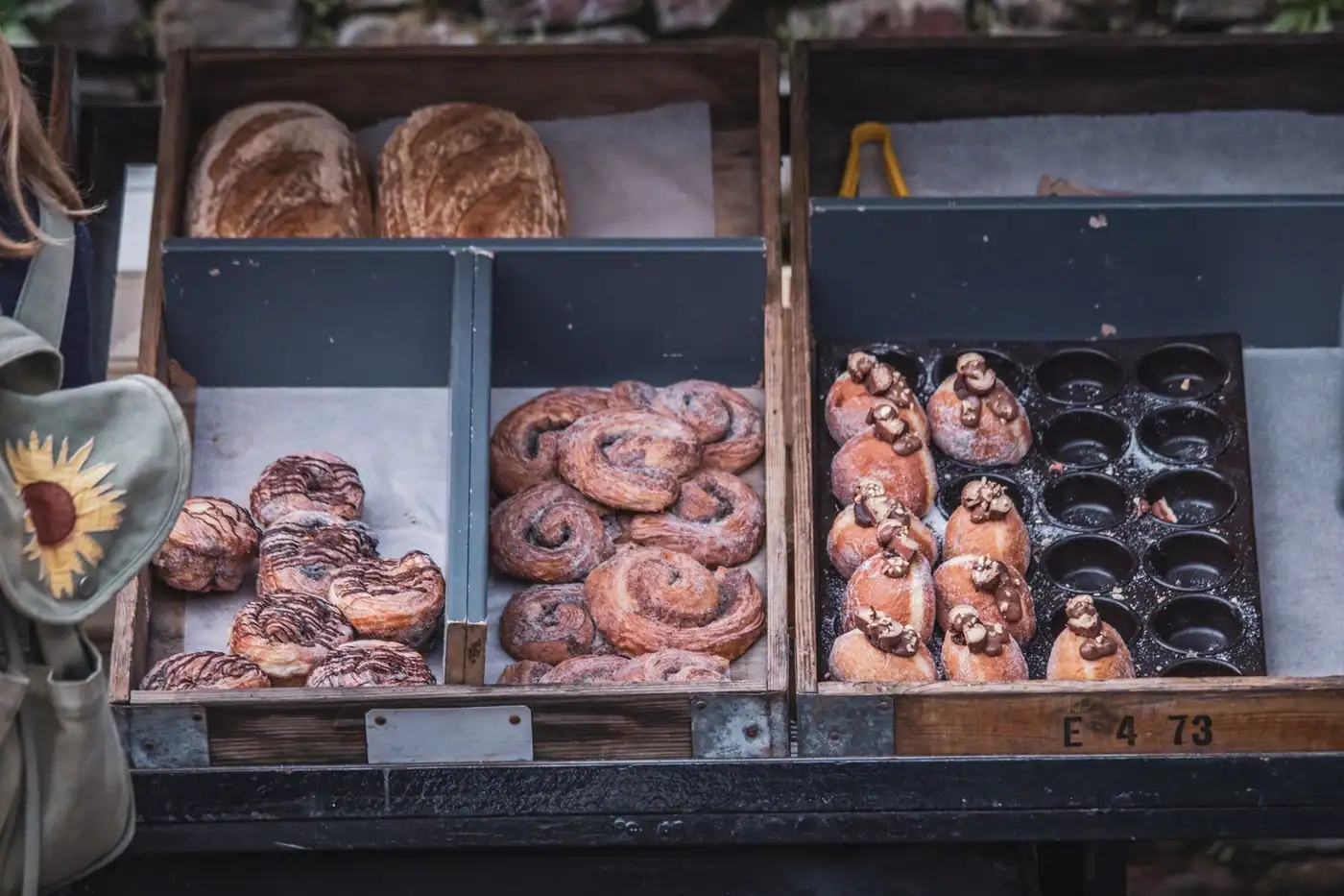 A variety of fresh artisanal pastries on display at an outdoor bakery stall
