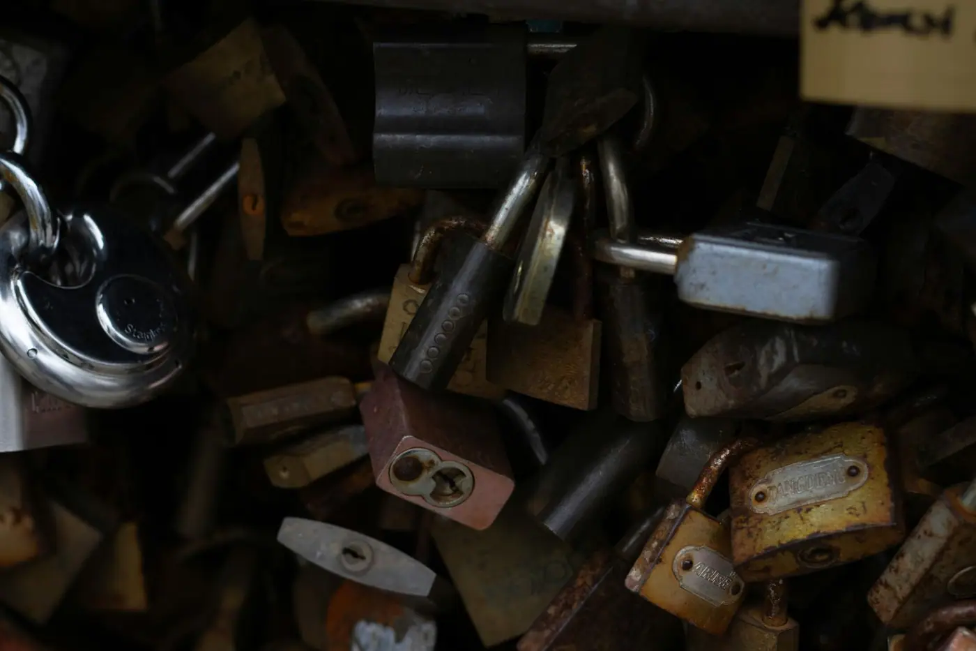 A pile of rustic and shiny padlocks