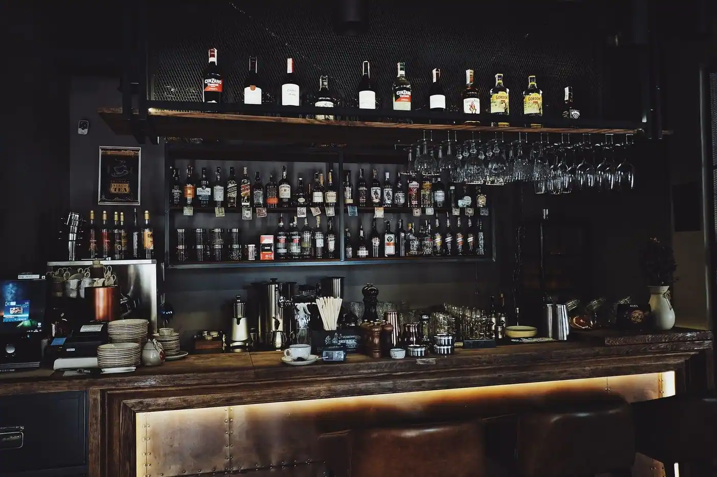 A stylish bar interior with a variety of spirits and glasses on the shelves