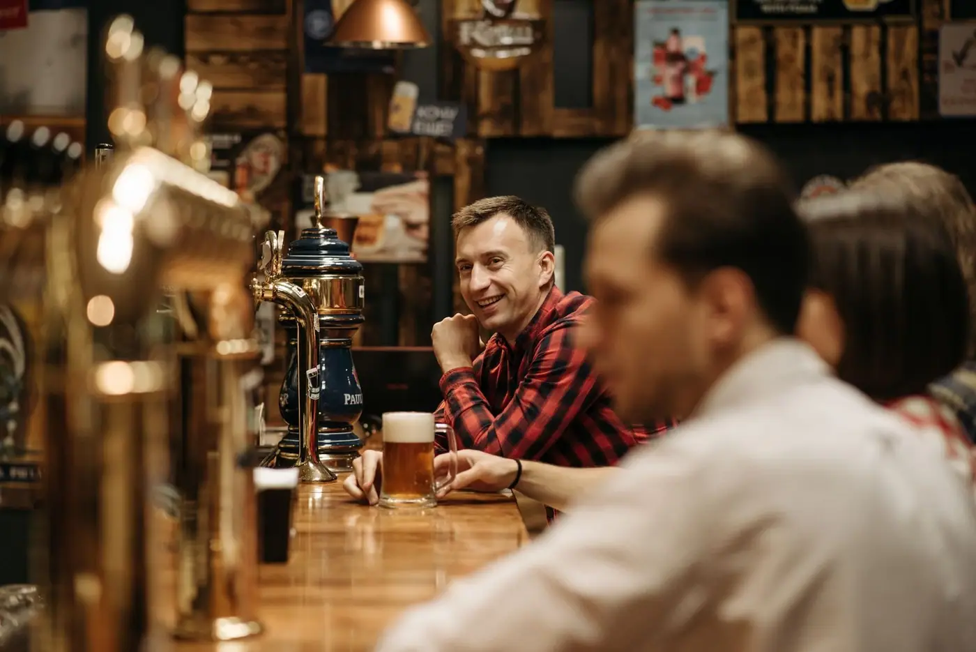 A cheerful group enjoying drinks together at a cosy pub bar