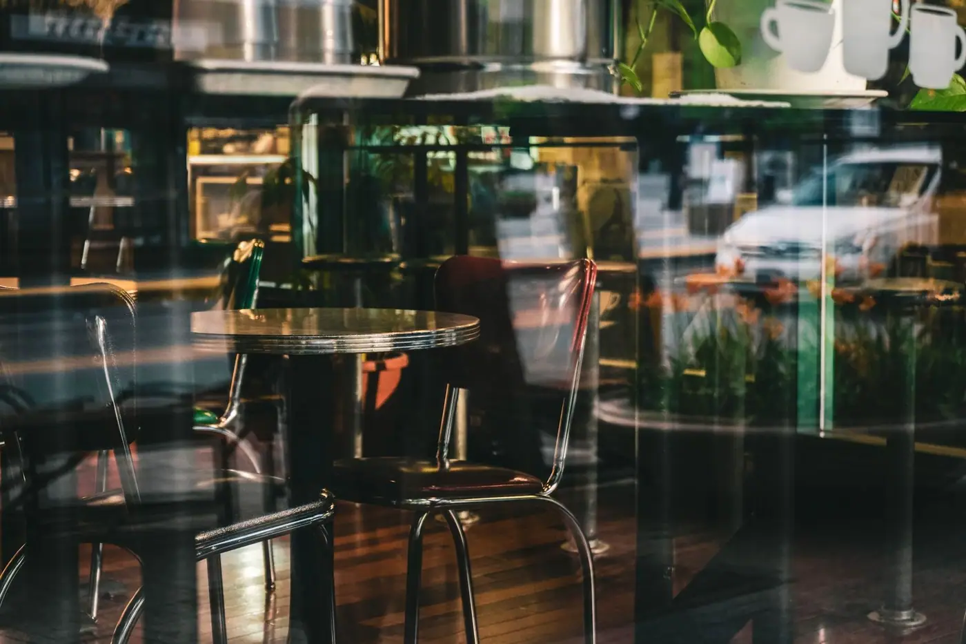 Elegant modern café interior with glass reflections and sleek furnishings