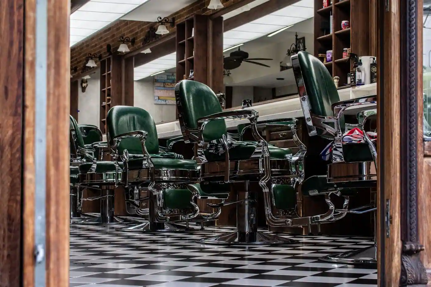Vintage barber shop with classic green chairs and checkered floor tiles