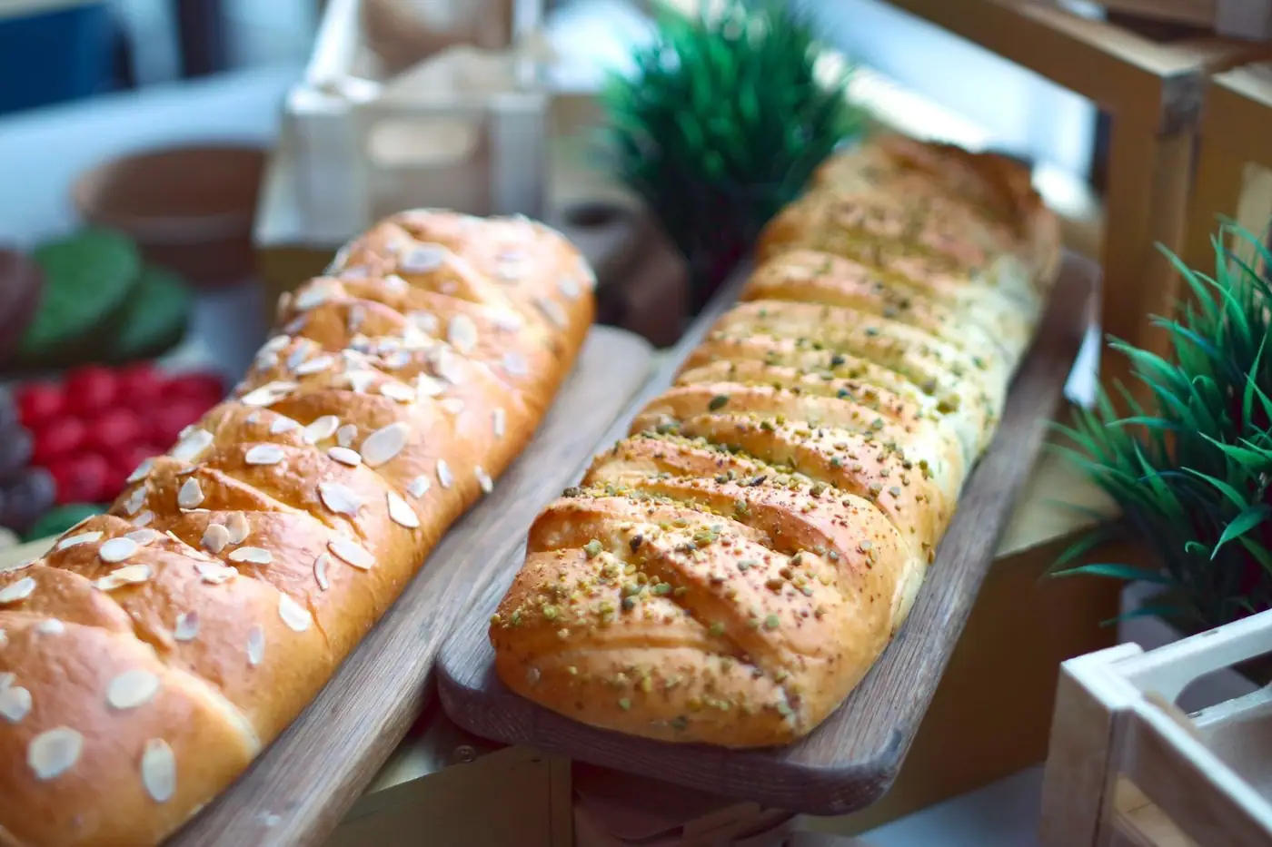 Close-up of artisan almond and herb bread on a wooden board