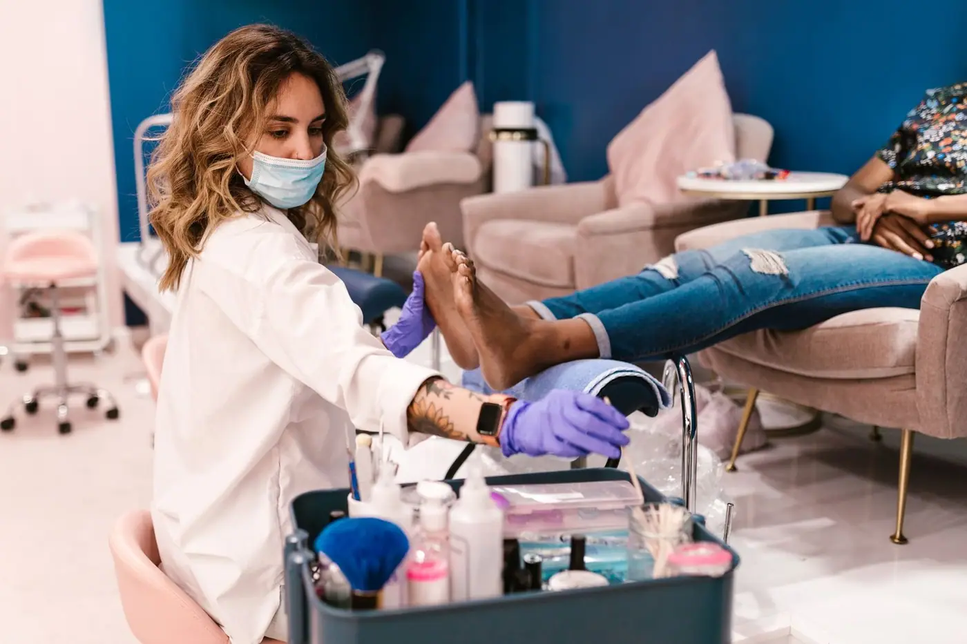 A beautician performing a pedicure on a client in a modern salon