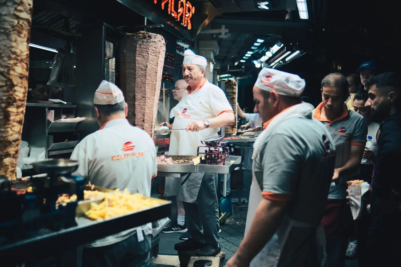 Chefs preparing kebab at a busy night street food stall