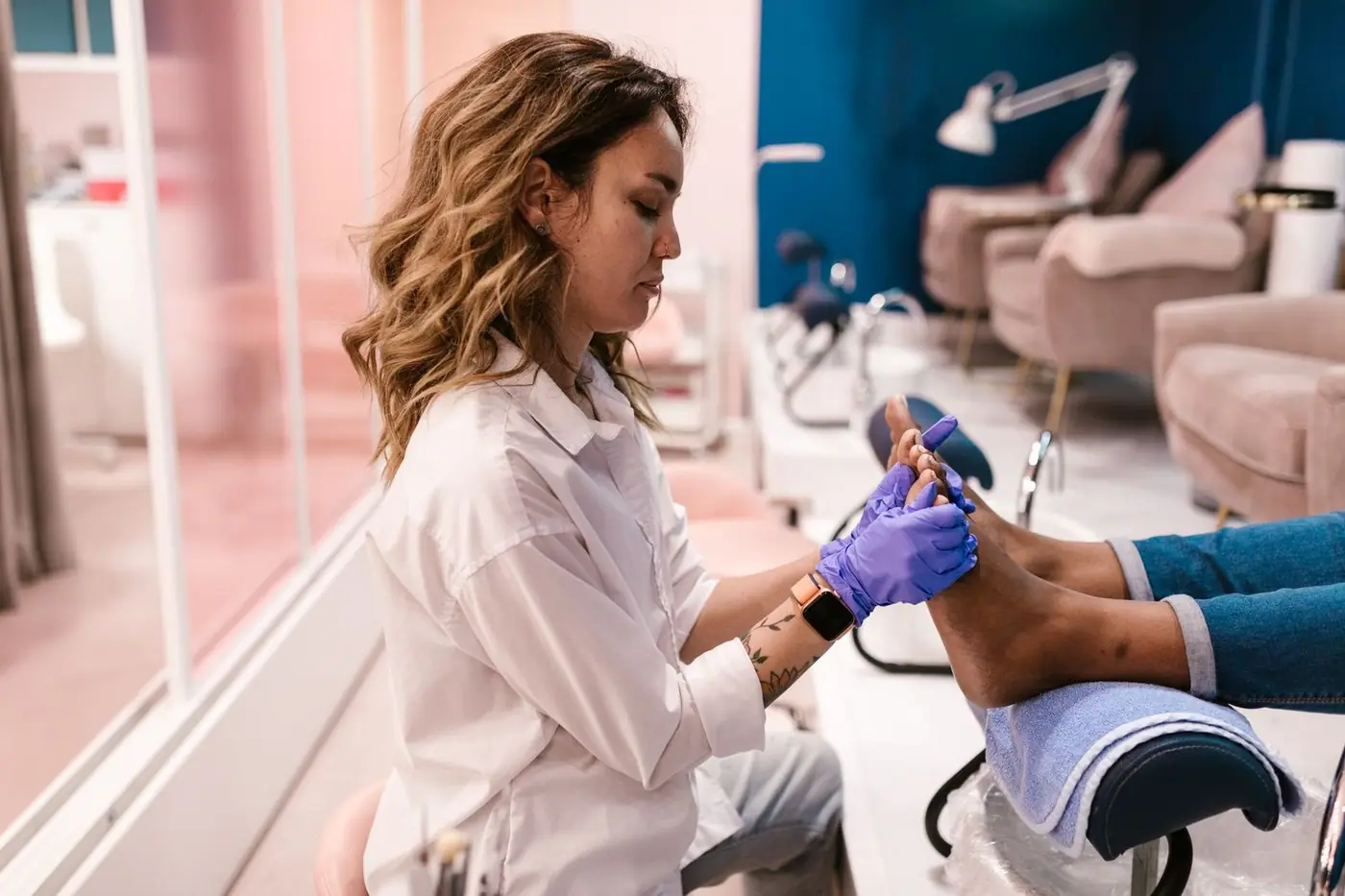 A woman giving a pedicure treatment in a stylish modern salon