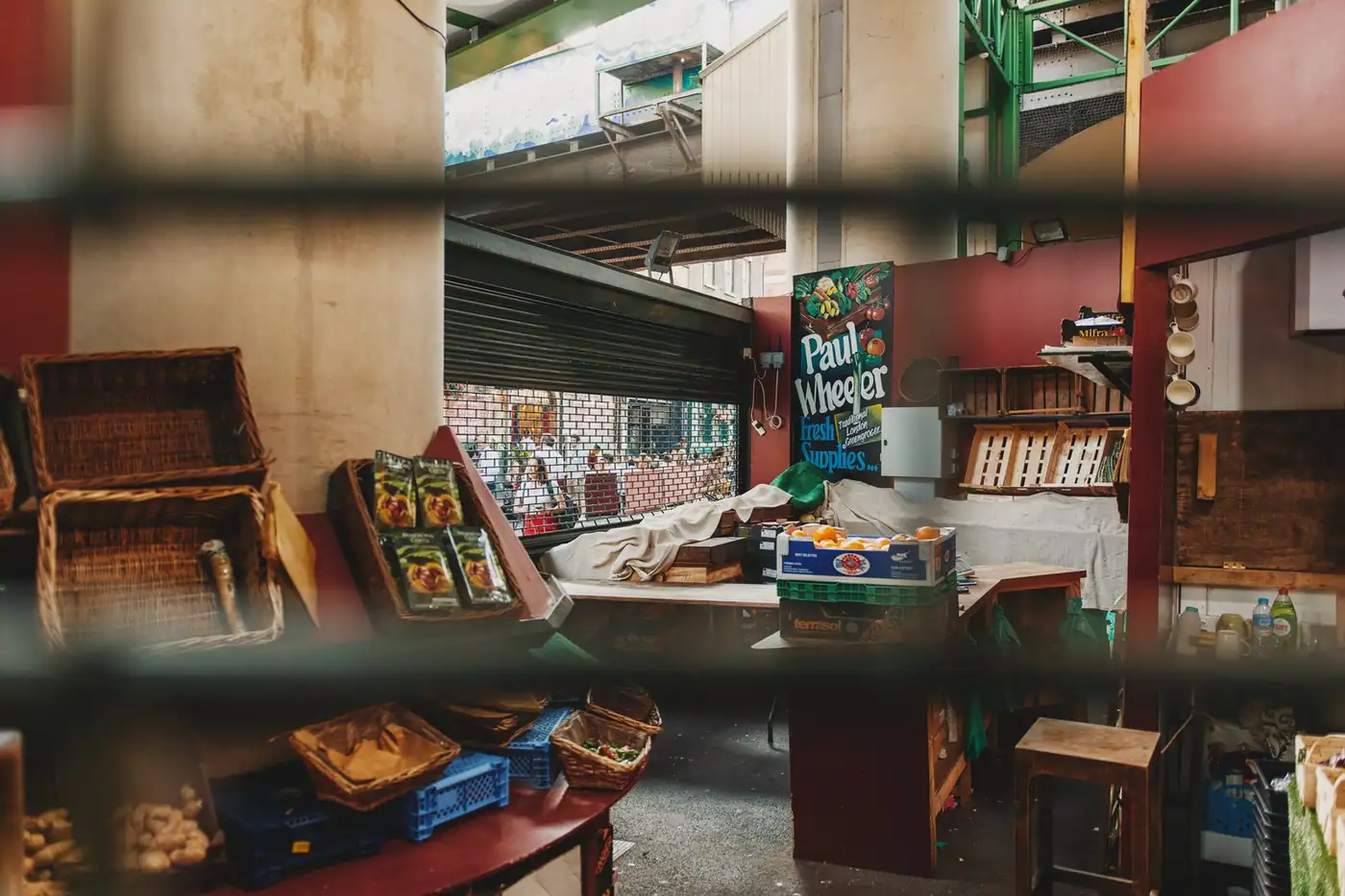 Market stall with wicker baskets and produce containers.