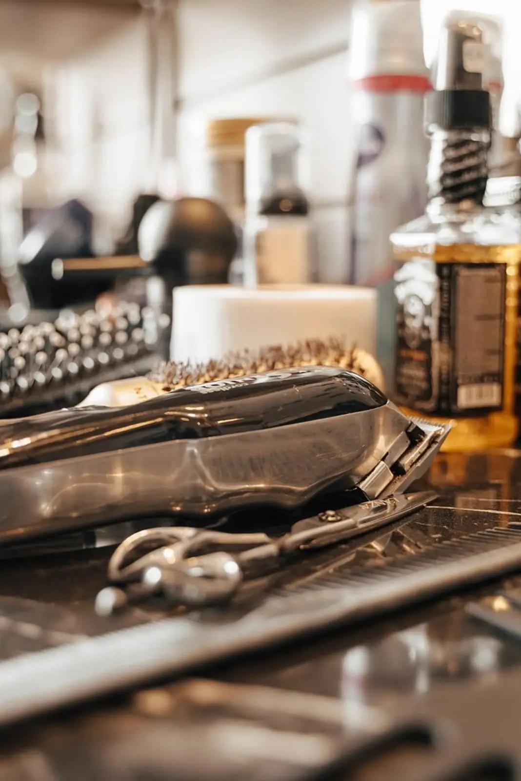 Close-up of barber tools and grooming products on a workstation in a barbershop, Belgium.