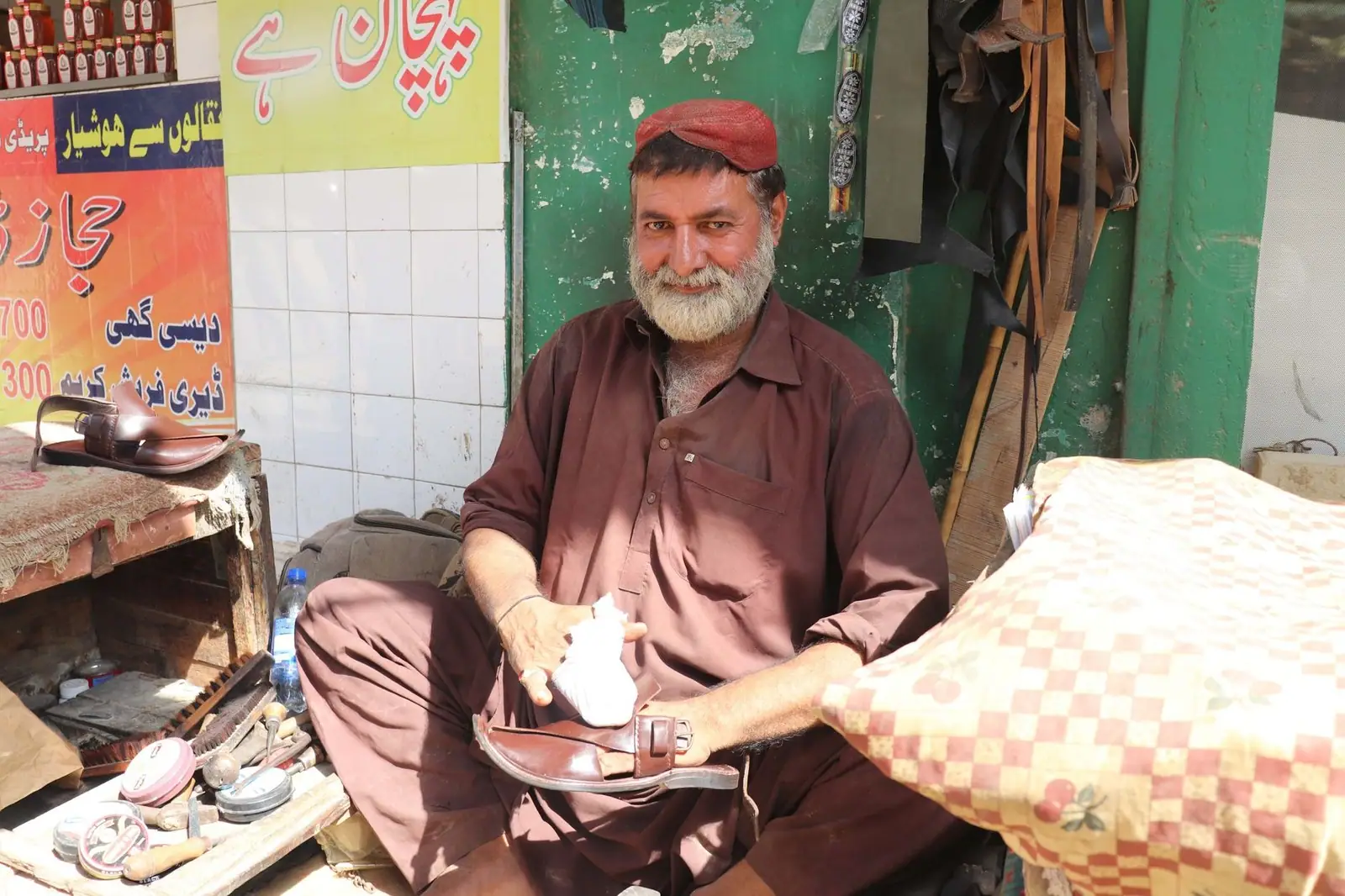 A skilled shoemaker at work in the bustling streets of Karachi