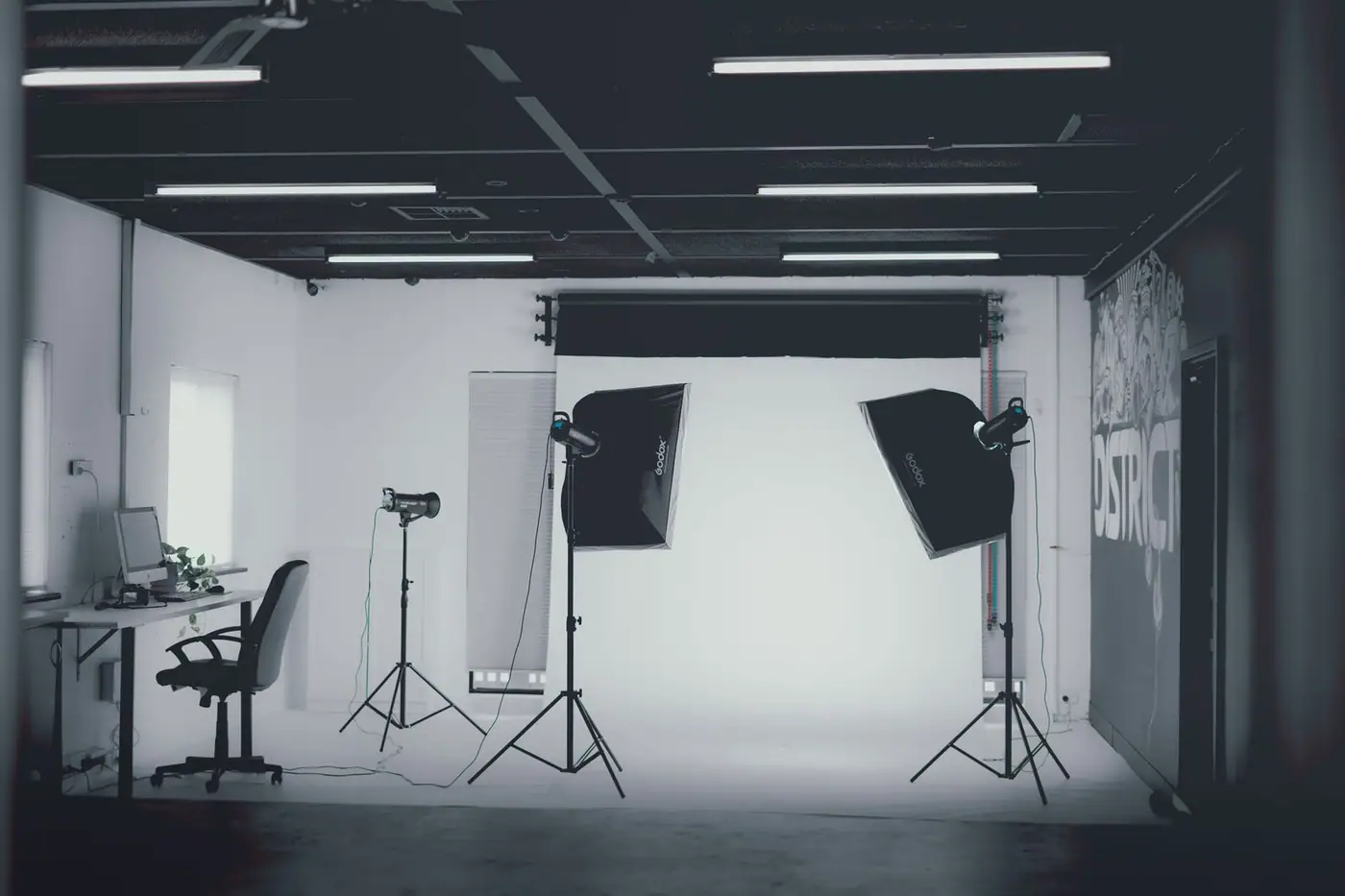 Modern photo studio in grayscale with softbox lighting
