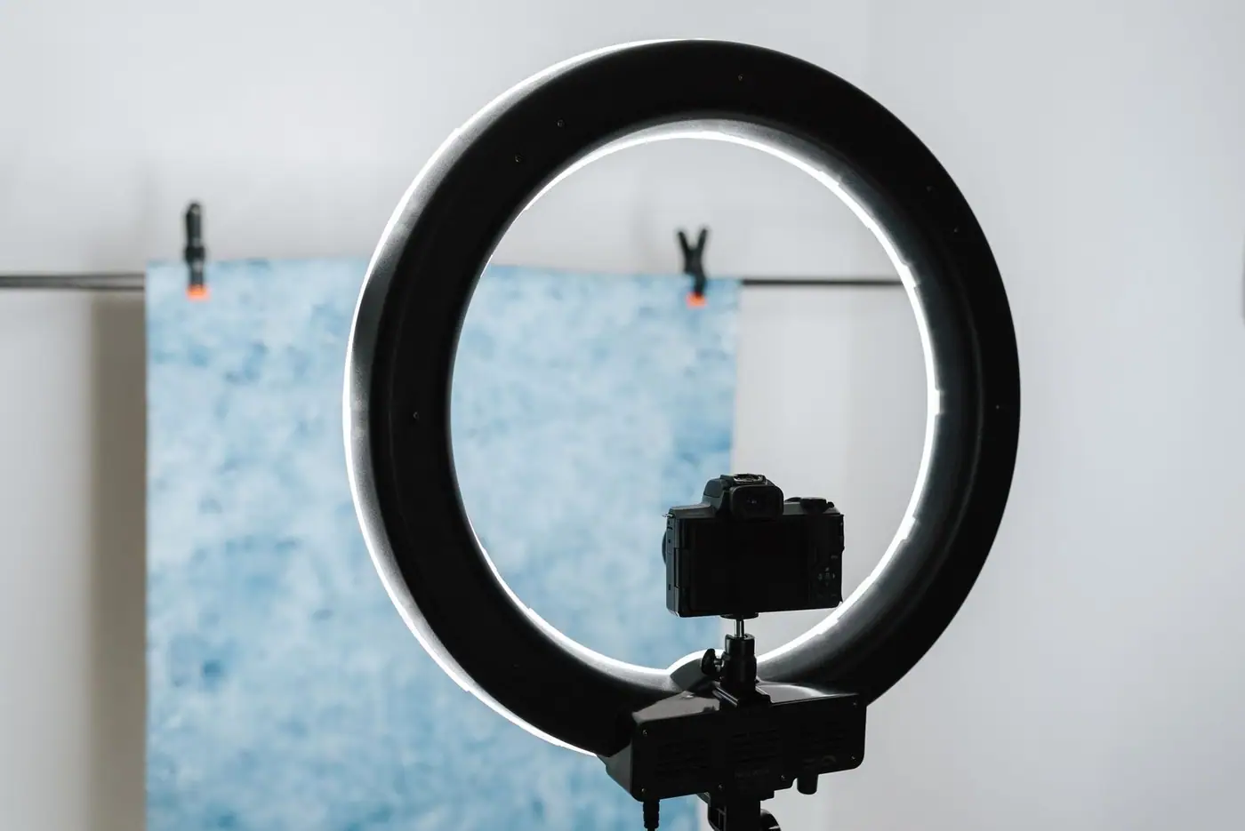 Contemporary photo camera and studio lamp prepared for a photo session in a professional studio
