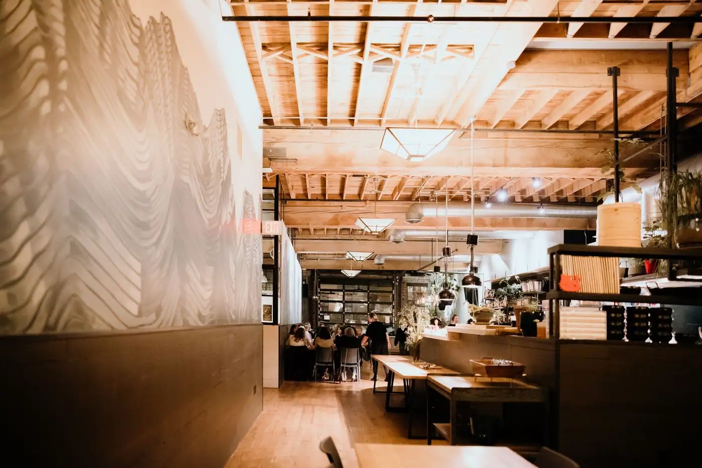 Stylish restaurant interior with a wooden ceiling and contemporary decor