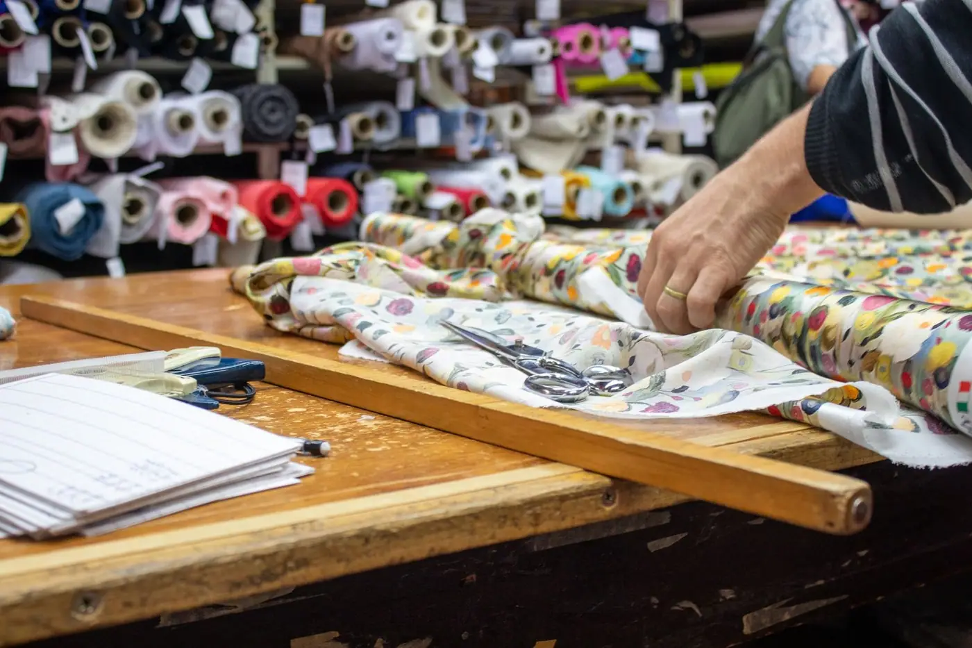 Close-up of hands cutting fabric with shears