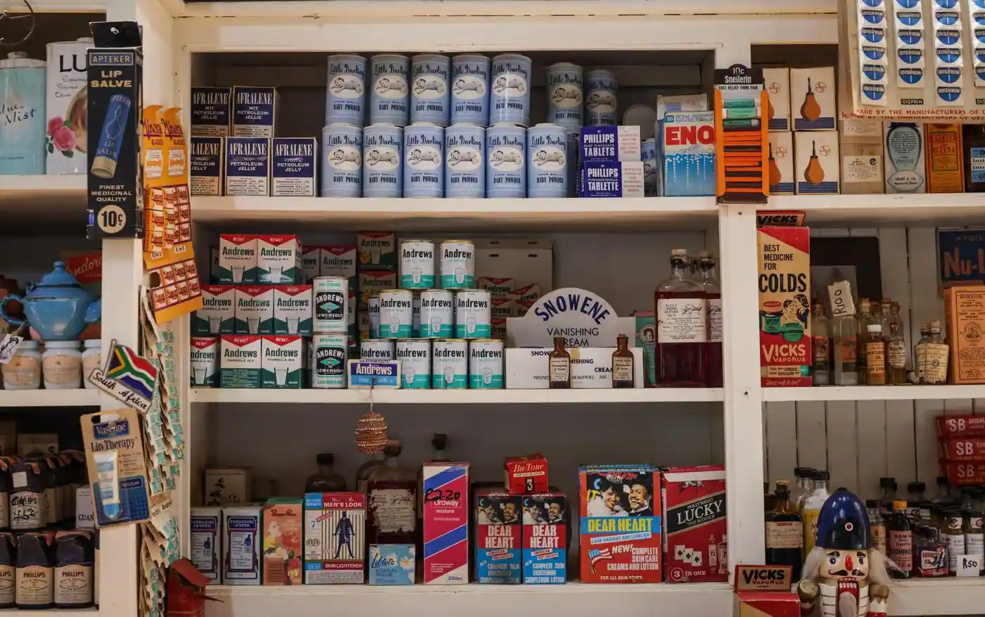 A vintage shop shelf with retro packaging of various products and medicinal items