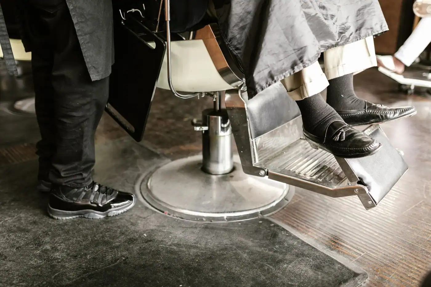 Leather loafers resting in a classic barber chair