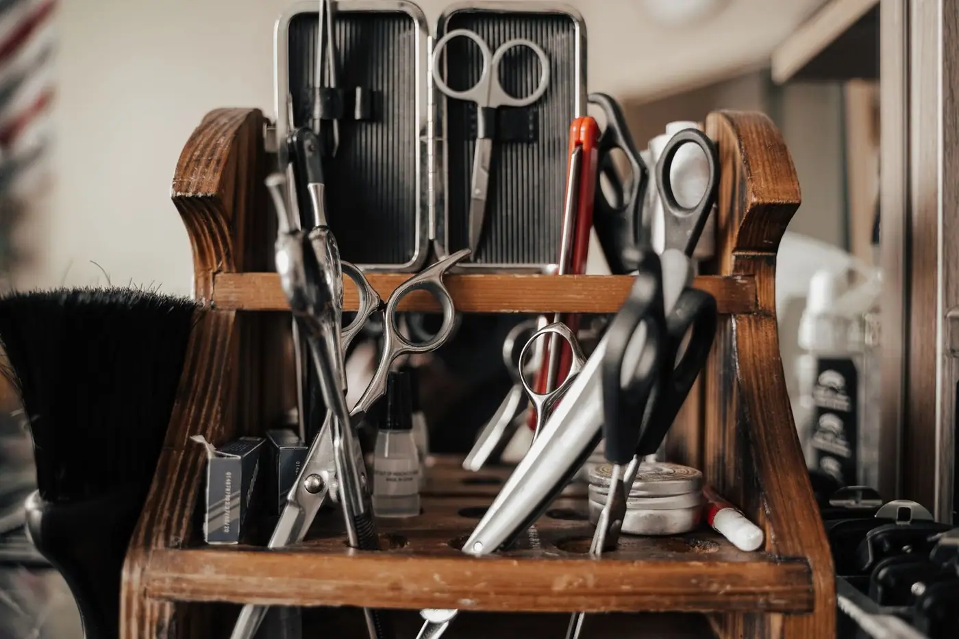 Close-up of barber tools on a wooden shelf in a barbershop