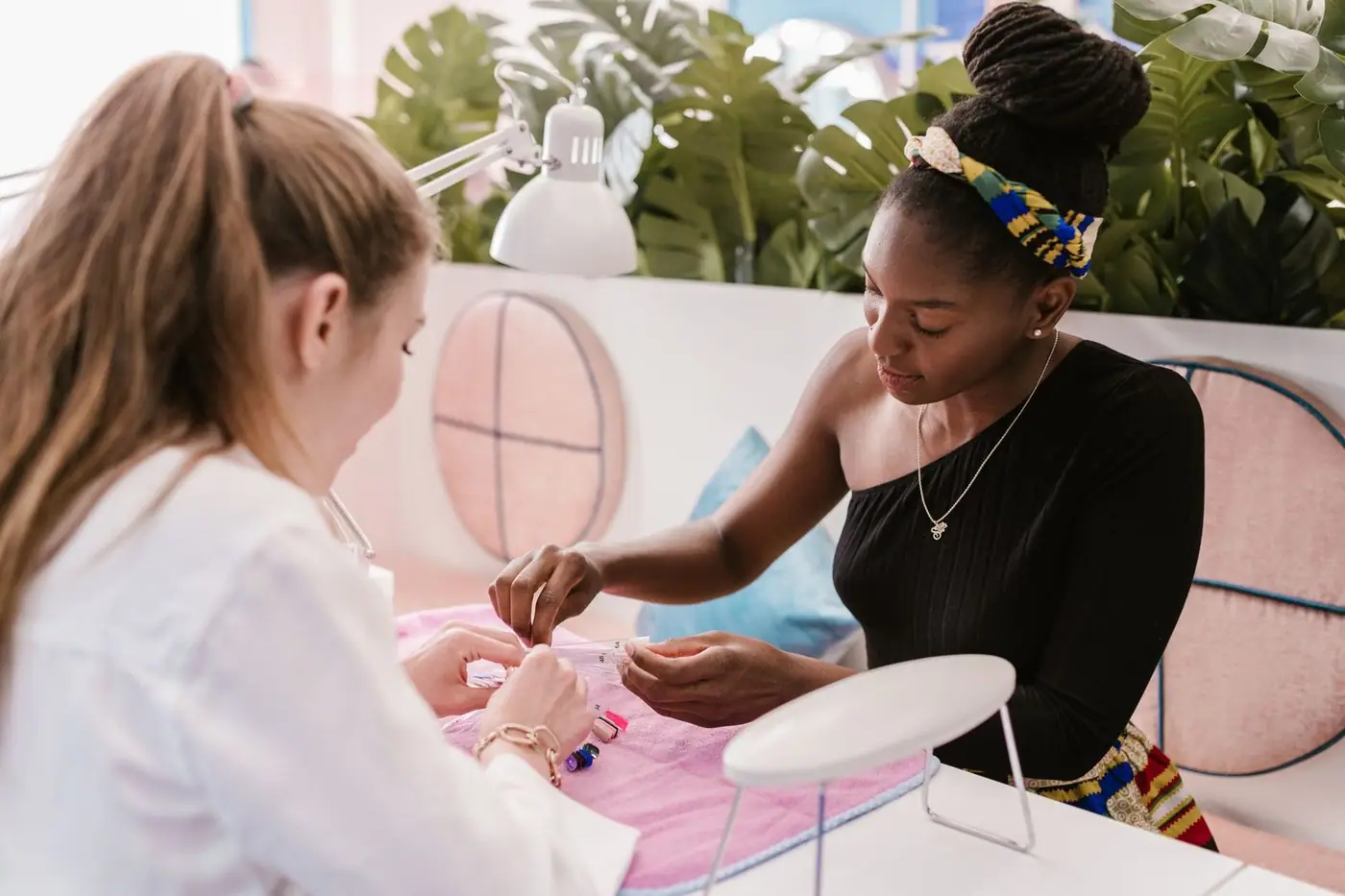 A manicurist giving nail care in a stylish, modern salon setting