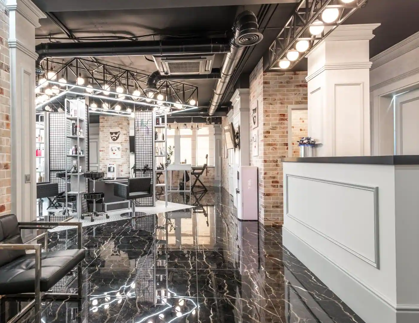 Stylish salon interior with black chairs and brick walls