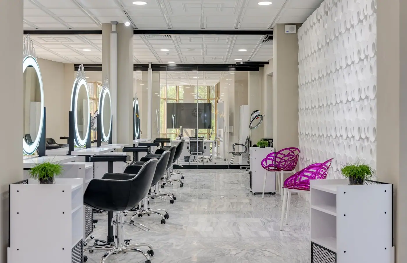Contemporary salon interior with sleek chairs and illuminated vanity mirrors
