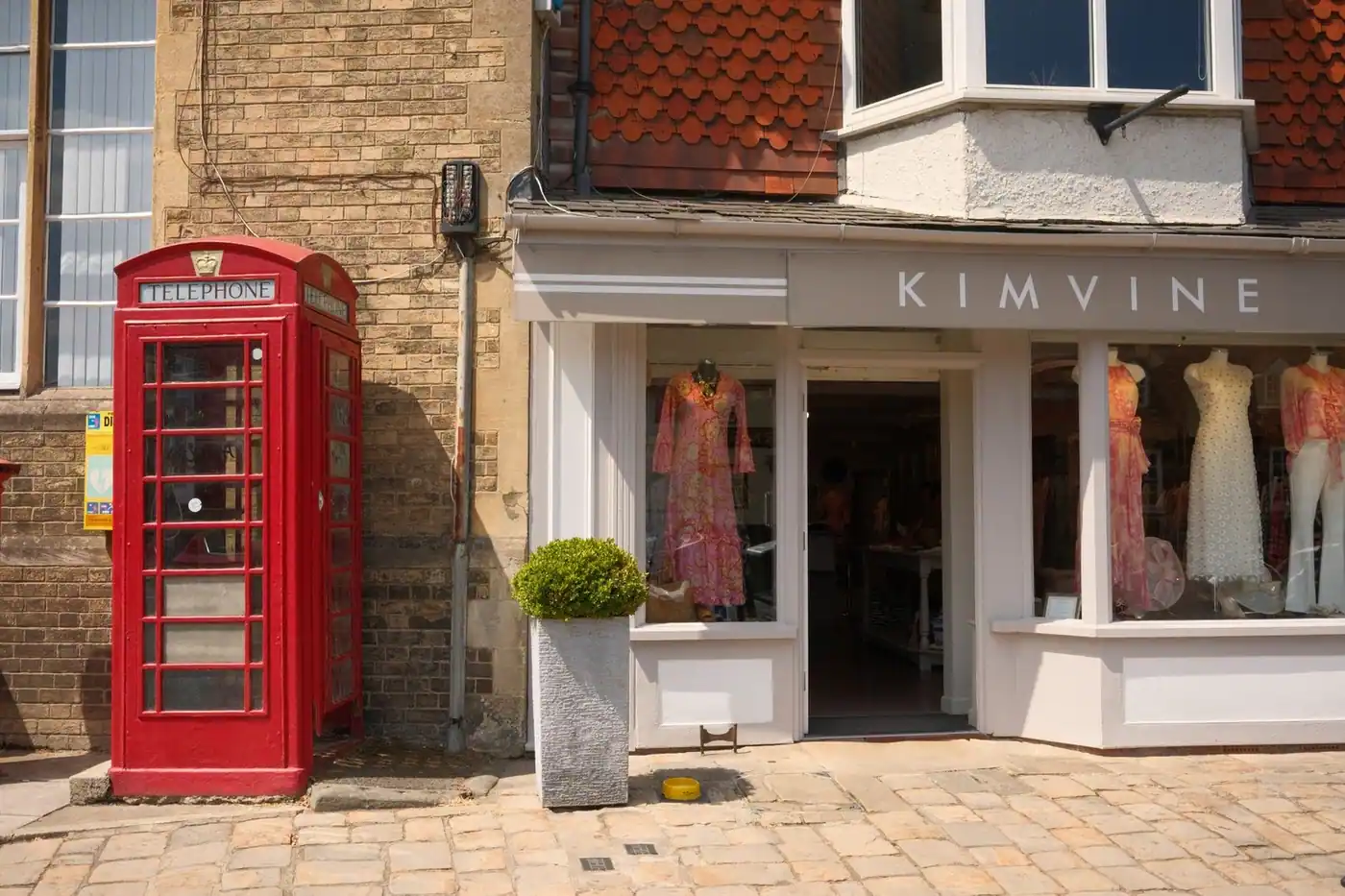 A red phone box beside a boutique in Marlborough, UK