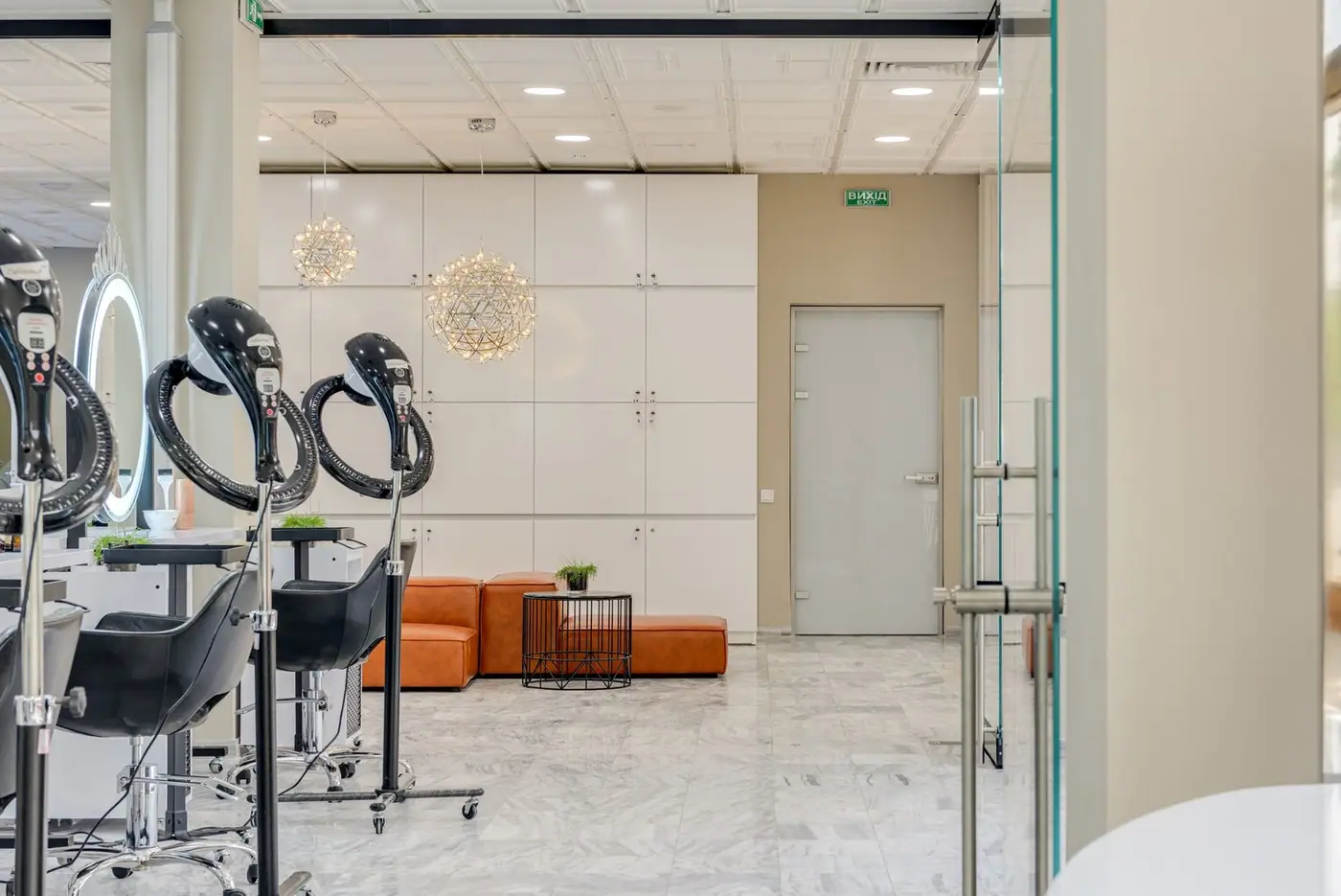 A stylish hair salon with sleek chairs, mirrors and marble flooring