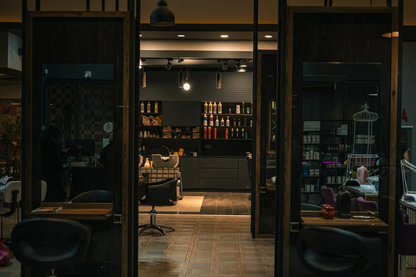 A cosy, stylish hair salon with modern decor and warm lighting at night