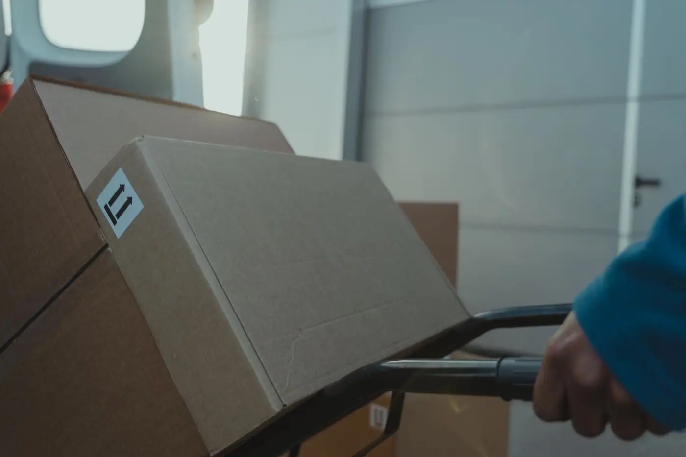 A cardboard box on a trolley inside a van