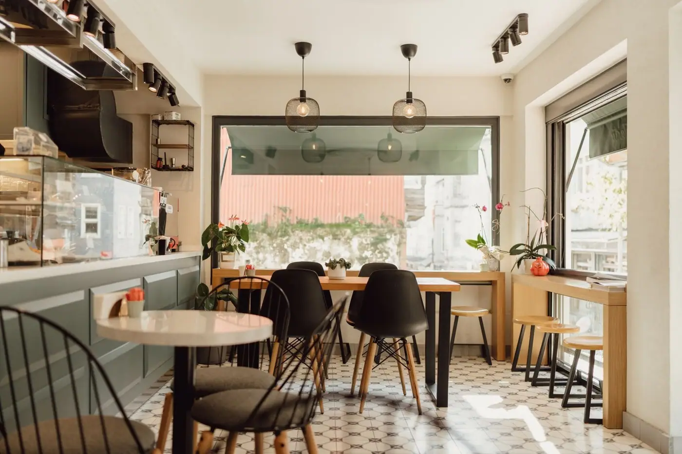 A modern, sunlit café with sleek furniture and minimalist design