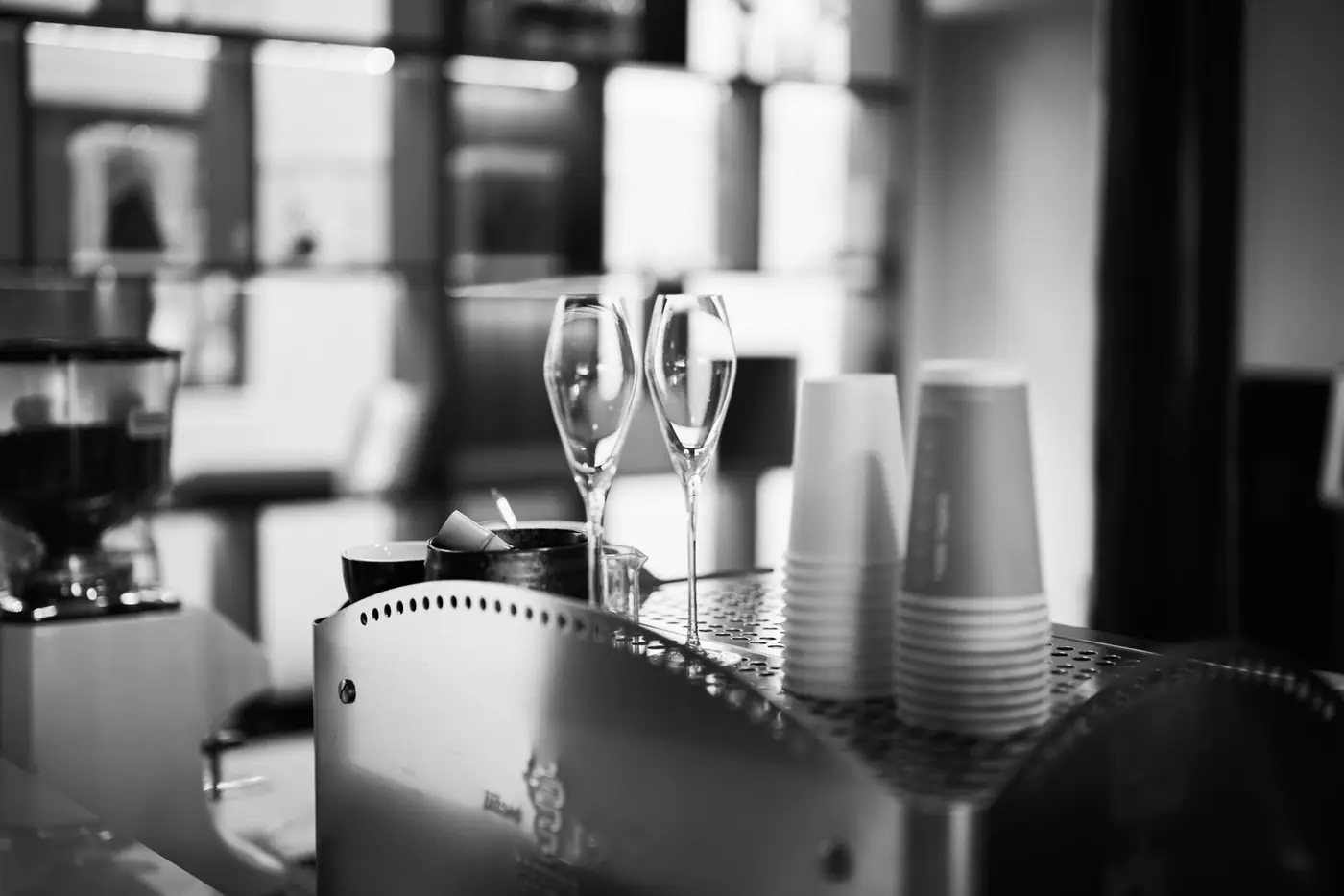Black and white coffee bar scene with stacked cups and glasses
