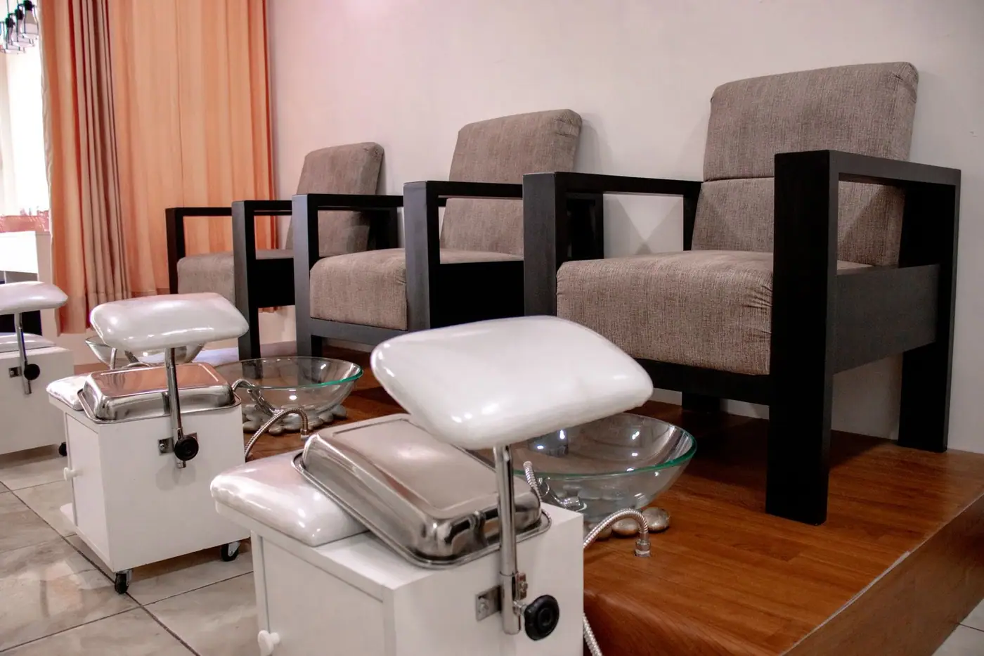 Pedicure chairs and foot baths in a modern salon setting