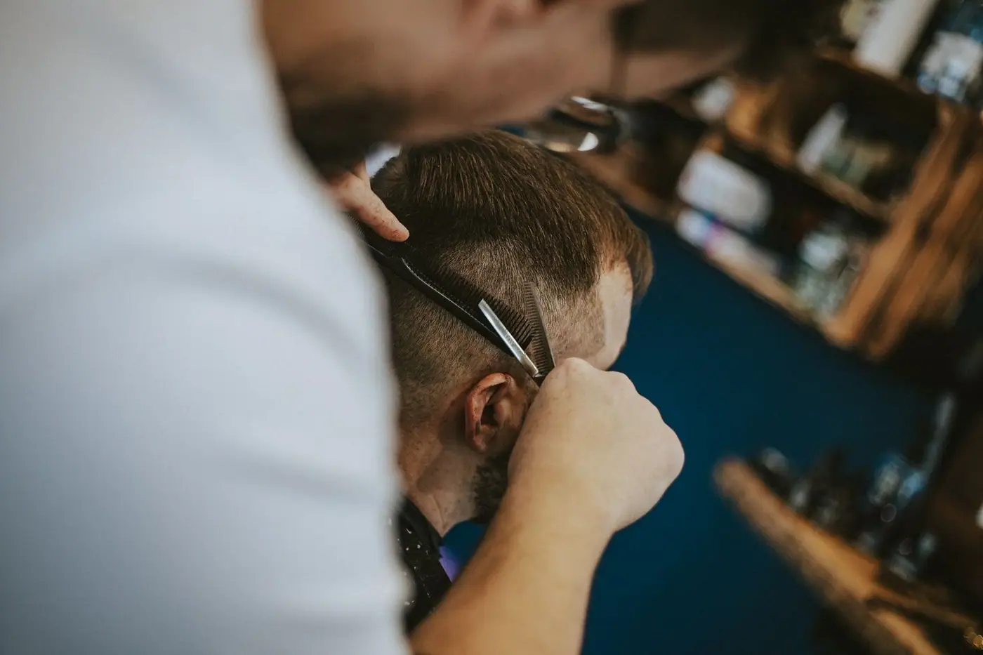 A barber giving a customer a haircut, the art of modern grooming and styling
