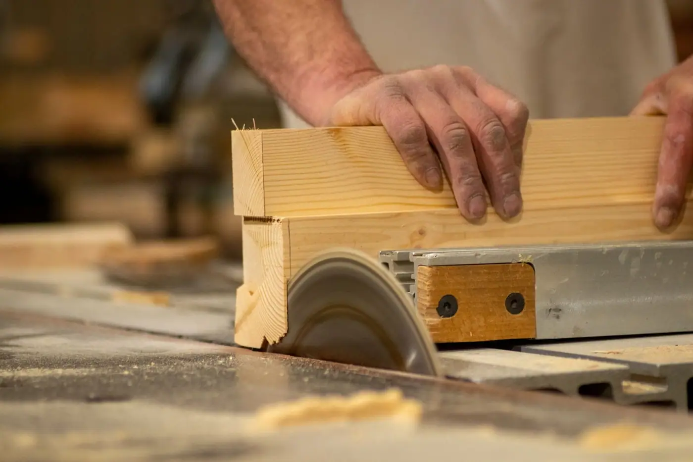 Close-up of a craftsman using a saw, cutting timber with care and precision