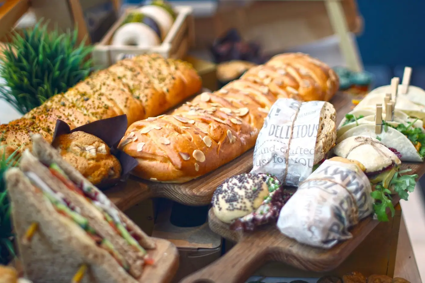 Close-up of artisan breads and sandwiches on a wooden platter