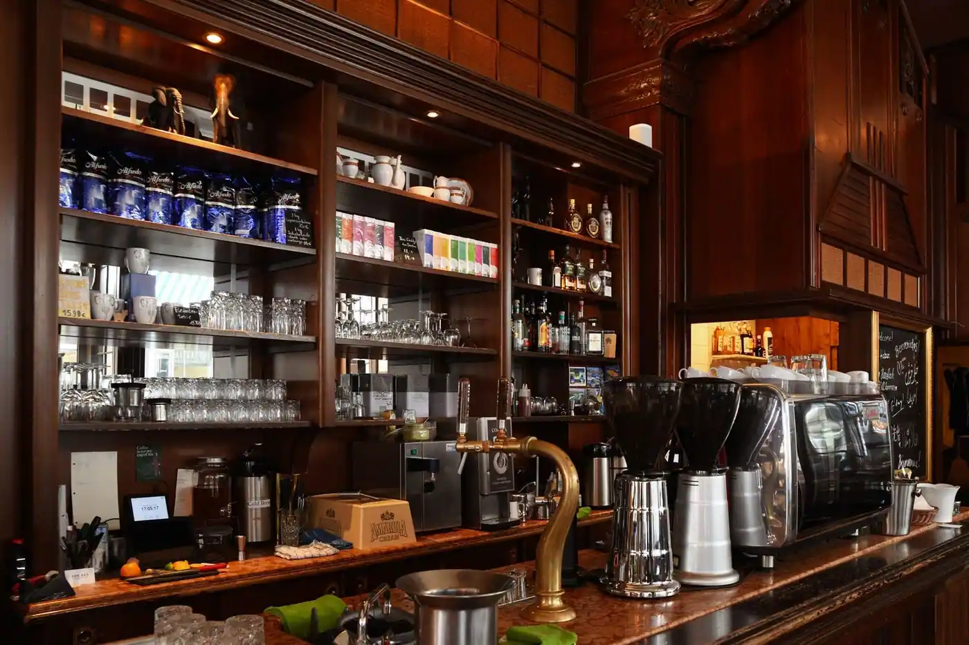 A coffee shop counter with an espresso machine and drinks set out