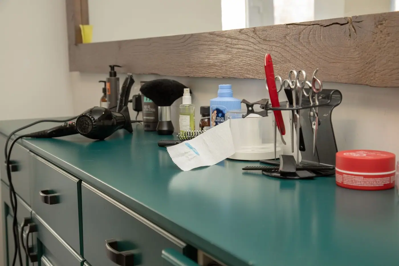 A well-organised salon workspace with hair styling tools on a cabinet