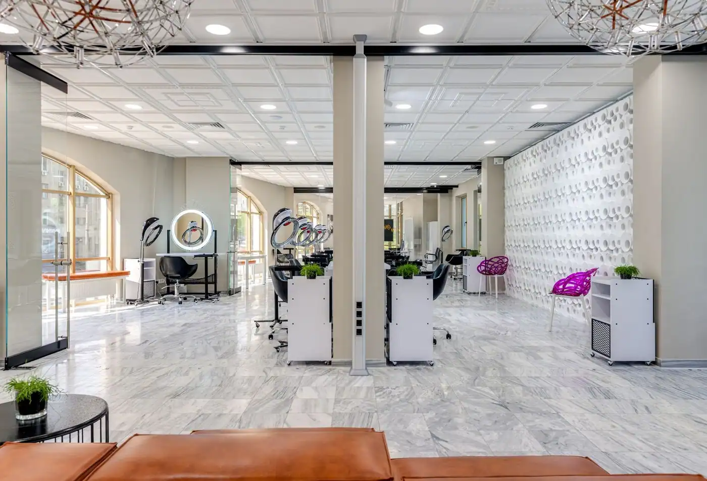 A sleek, modern beauty salon interior with comfortable seating