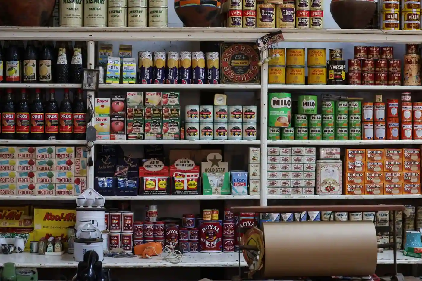 A vintage grocery store shelf filled with retro products and packaging from various brands.